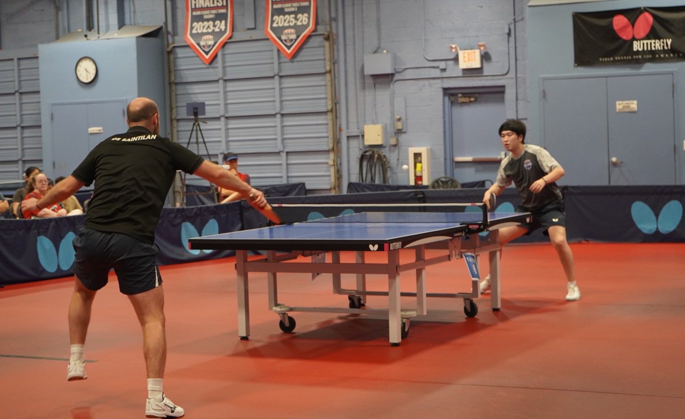 Close-up of two players mid-rally over the net