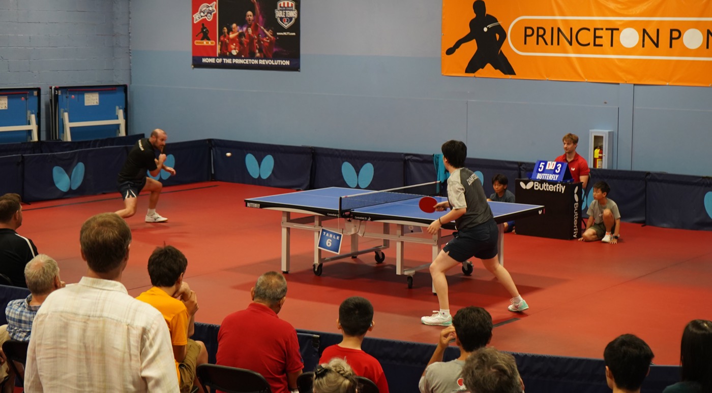 A match seen from the crowd with the Princeton Pong banner behind