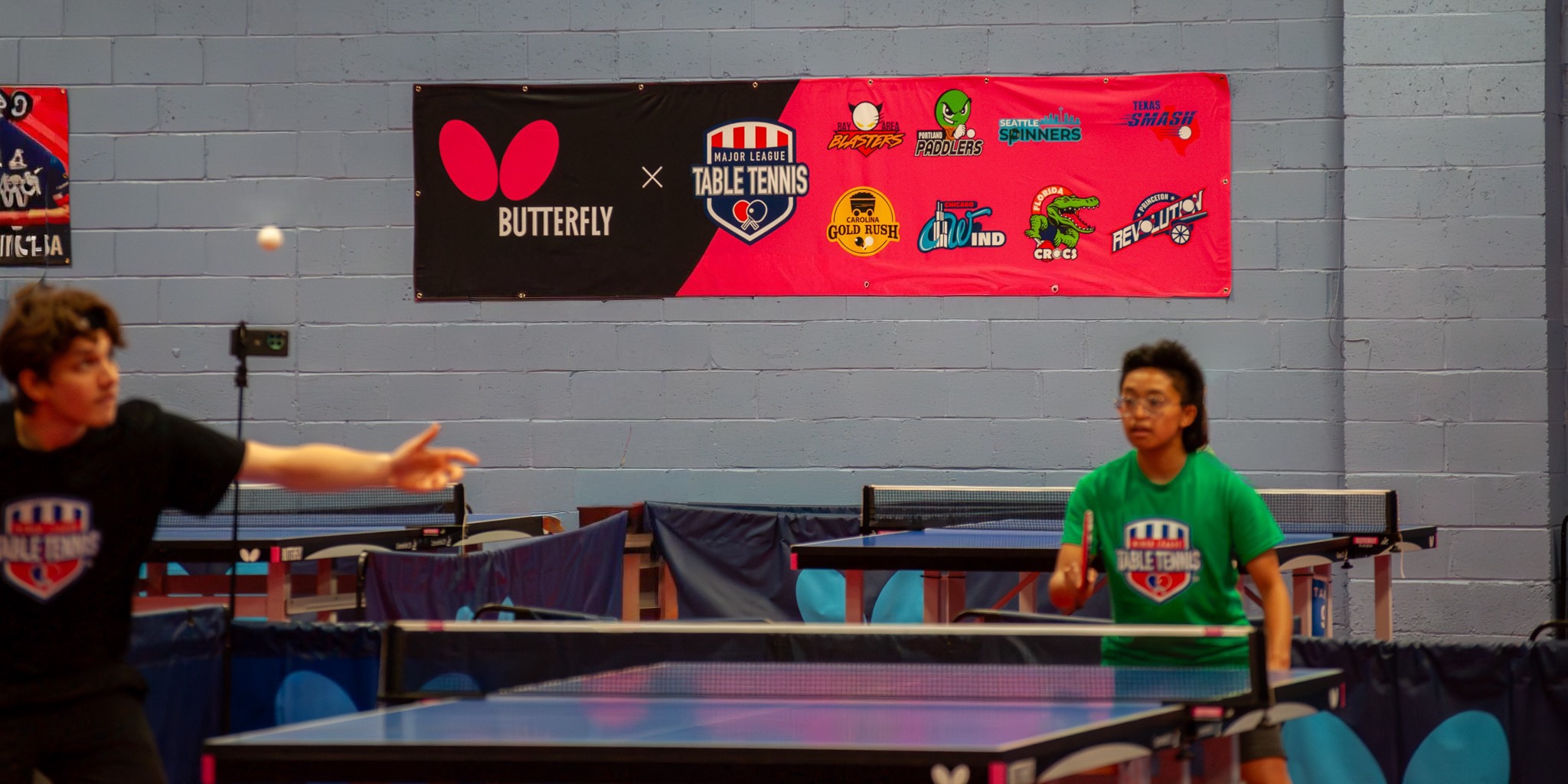 Players rally beneath the Major League Table Tennis banner at Princeton Pong