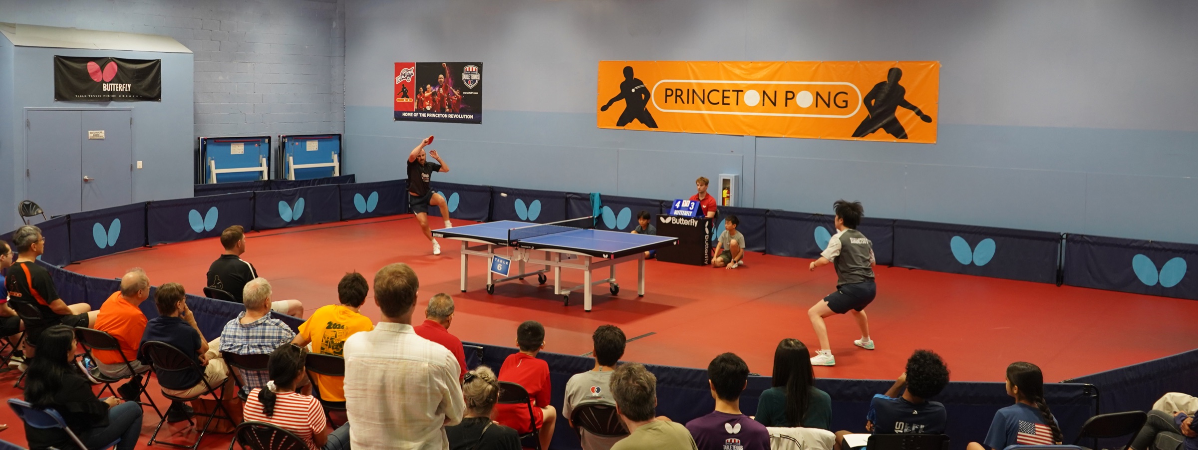 A Princeton Pong player lunges low to return the ball during an exhibition match