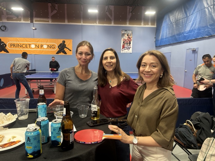 A group socializing over drinks during a private rental at Princeton Pong