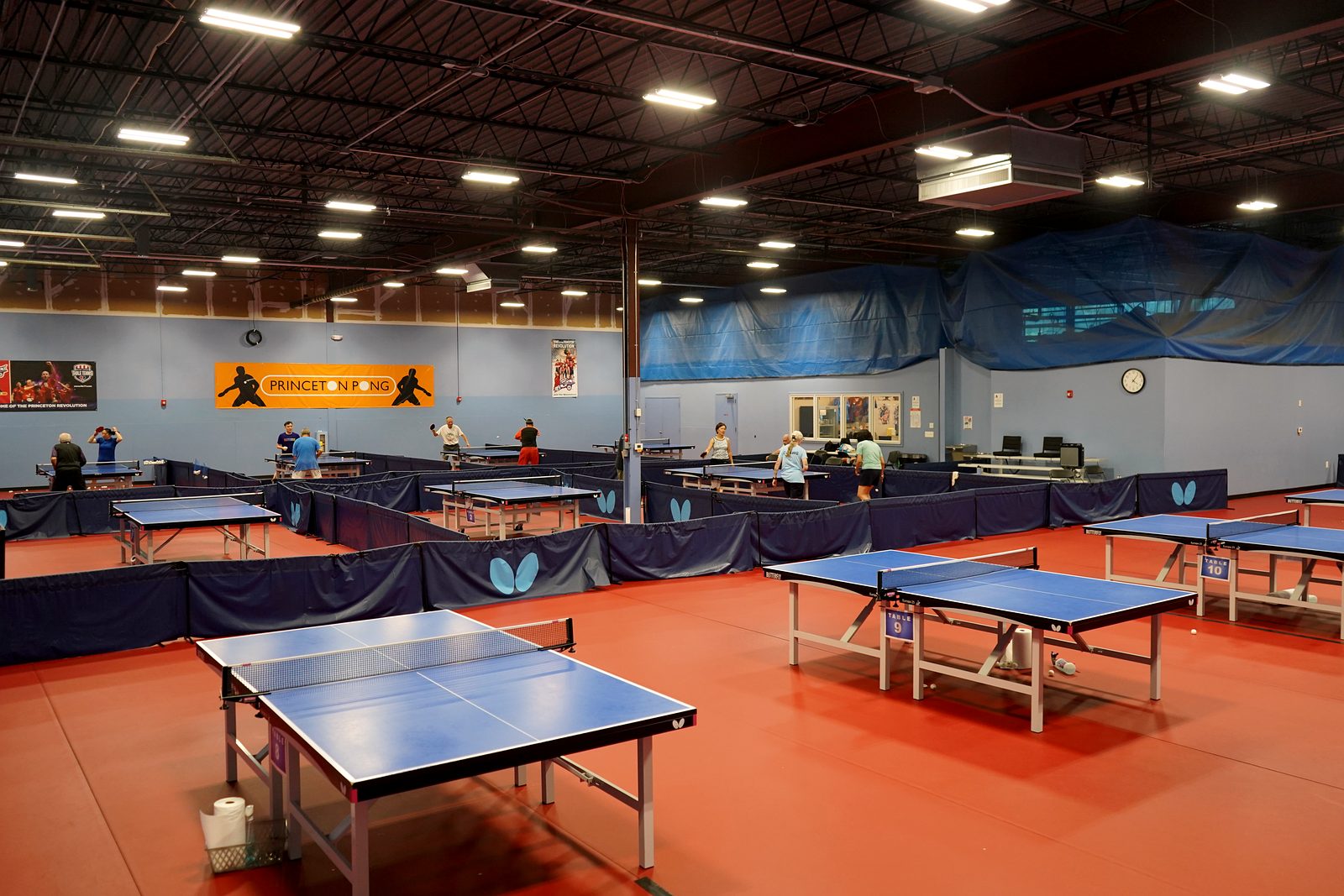 The main hall with players and the orange Princeton Pong banner on the wall
