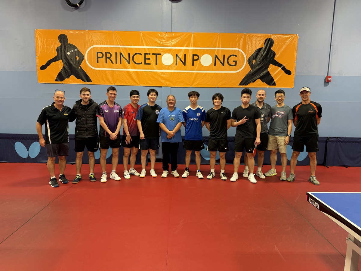 Players and coaches lined up under the Princeton Pong banner after a September tournament
