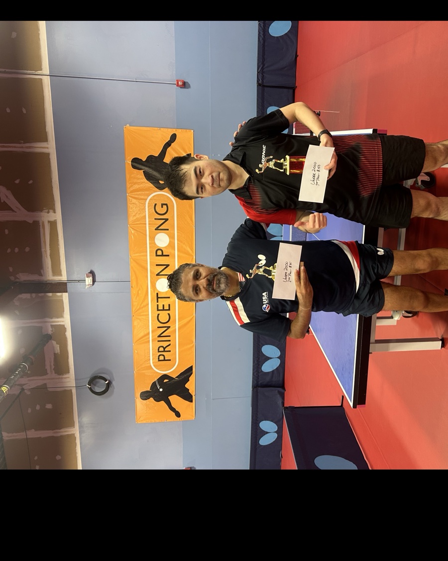 Under 2000 division winners holding their trophies and prize envelopes at Princeton Pong